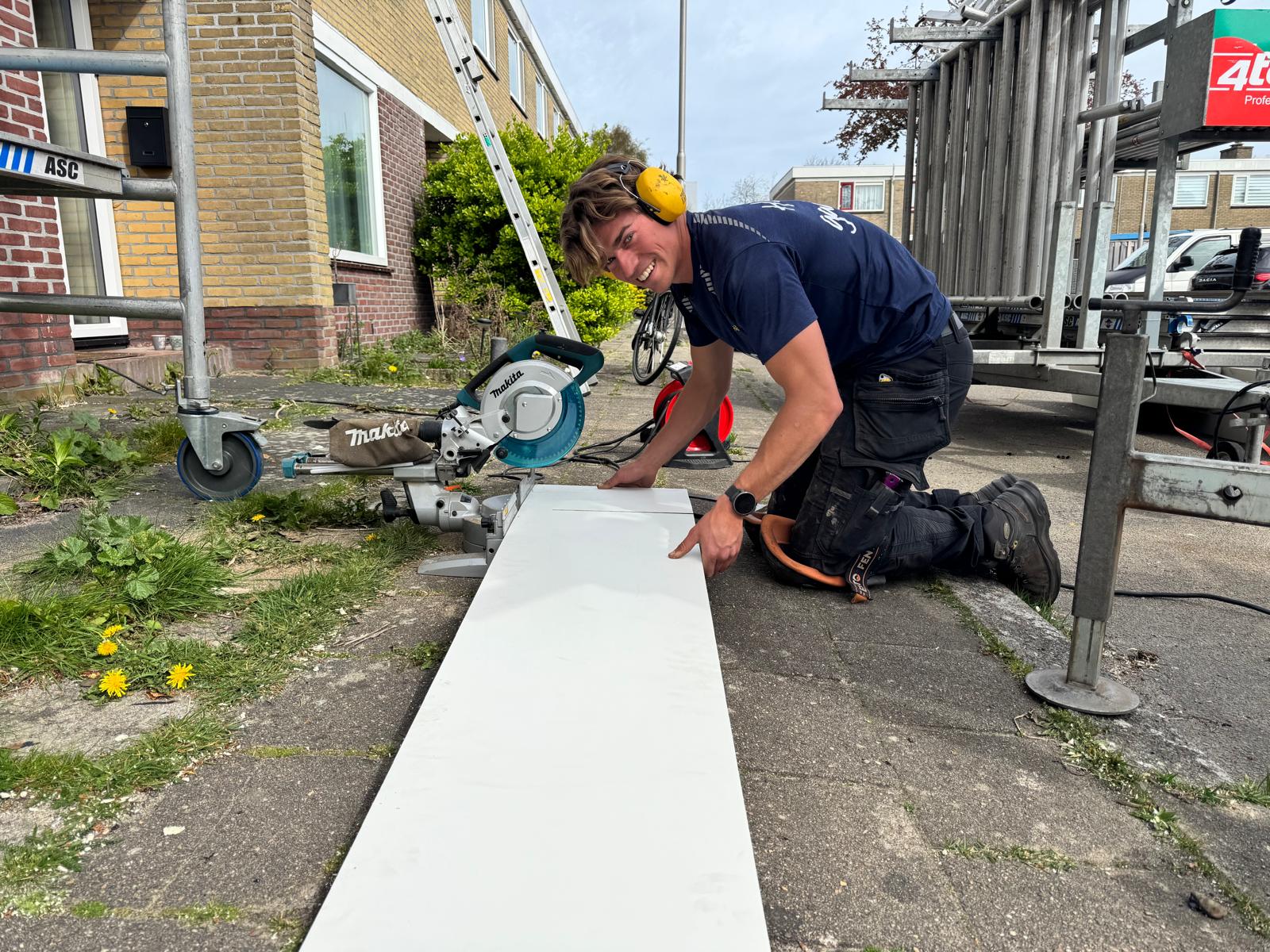 Vakman van AddRoof met een lach aan het werk, degelijk en persoonlijk